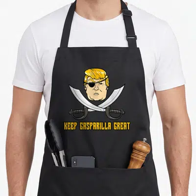 Gasparilla florida apron - Trump pirate caricature with crossed silver cutlasses and yellow KEEP GASPARILLA GREAT text — shown on a black cotton canvas apron against a white background