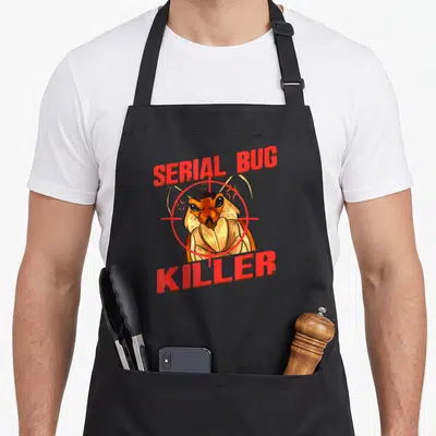 Pest tung apron - Cartoon bug with red crosshair and text SERIAL BUG KILLER — shown on a black cotton canvas apron against a white background