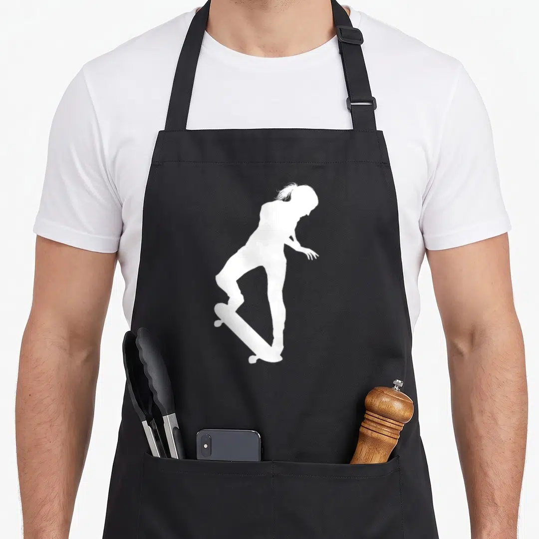 Skateboarder skateboard apron - White silhouette of a girl riding a skateboard on grey background — shown on a black cotton canvas apron against a white background