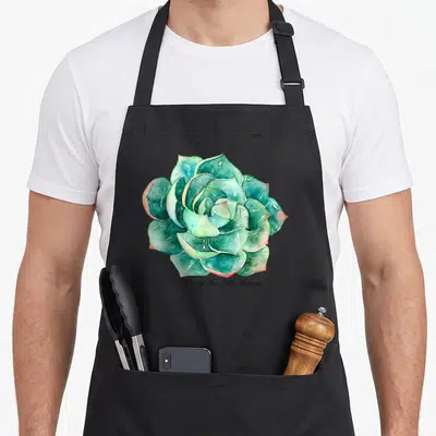 Inspiration succulent apron - Watercolor teal succulent with black cursive text Enjoy the little things below — shown on a black cotton canvas apron against a white background
