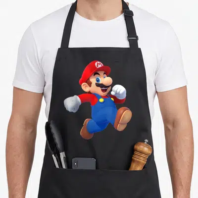 Poster running apron - Mario character jumping in red hat blue overalls white gloves brown shoes — shown on a black cotton canvas apron against a white background