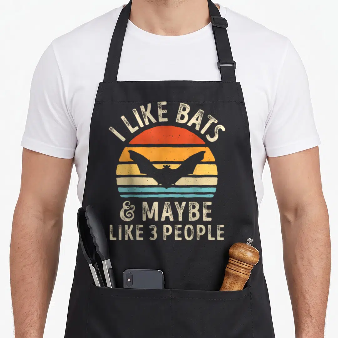 Maybe bat apron - Retro sun with bat silhouette and text I like bats and maybe 3 people — shown on a black cotton canvas apron against a white background