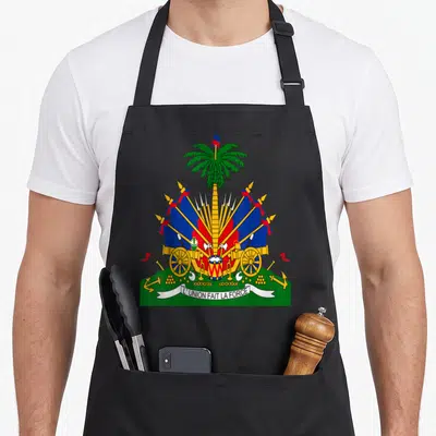 Coat haitian boy apron - Haitian coat of arms with palm tree, cannons, flags, and banner reading L'UNION FAIT LA FORCE — shown on a black cotton canvas apron against a white background