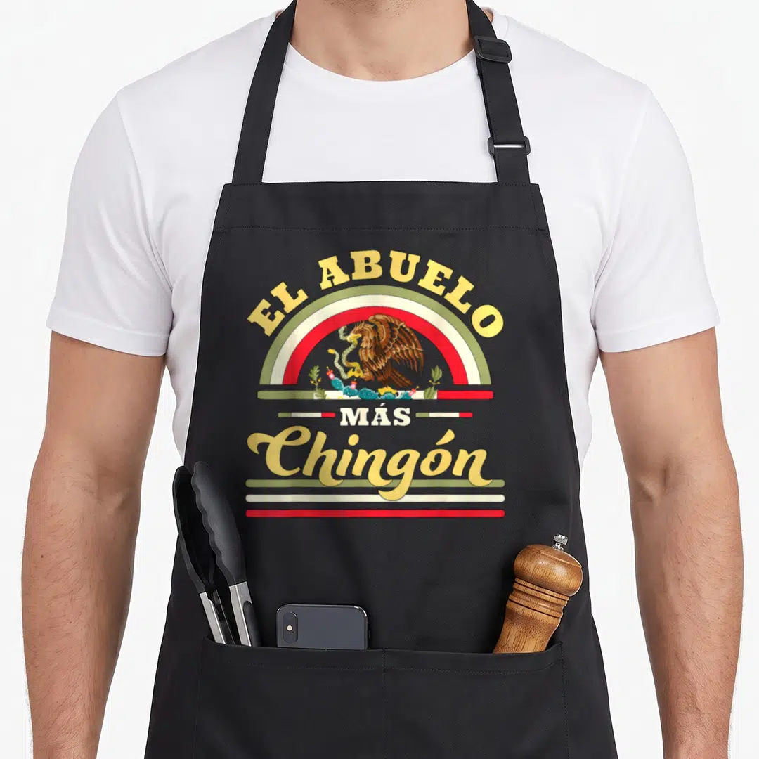 Abuelo mexican apron - Retro eagle and rainbow graphic with EL ABUELO MÁS Chingón text in yellow red green white — shown on a black cotton canvas apron against a white background