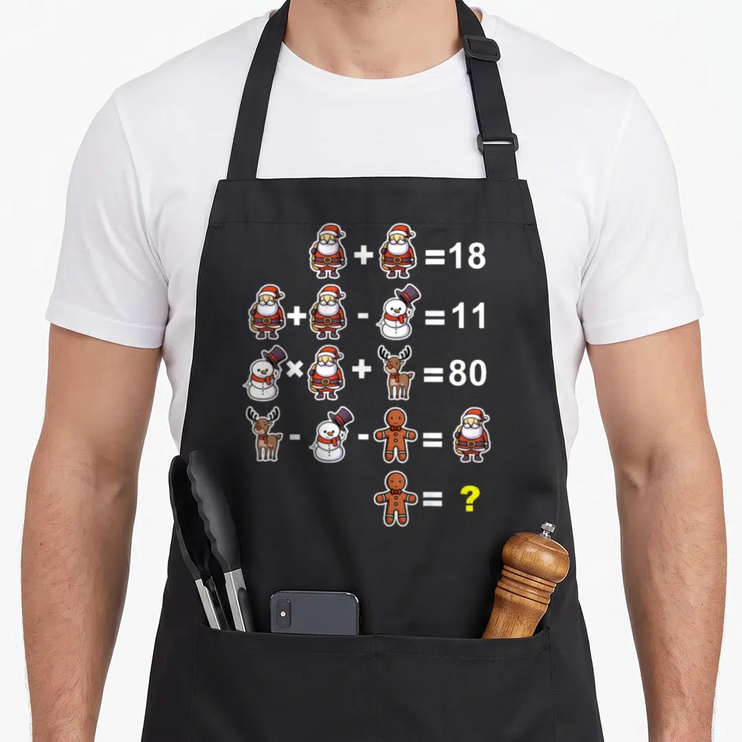 Operation quiz christmas apron - Five math equations with Santa, snowman, reindeer, and gingerbread man variables — shown on a black cotton canvas apron against a white background
