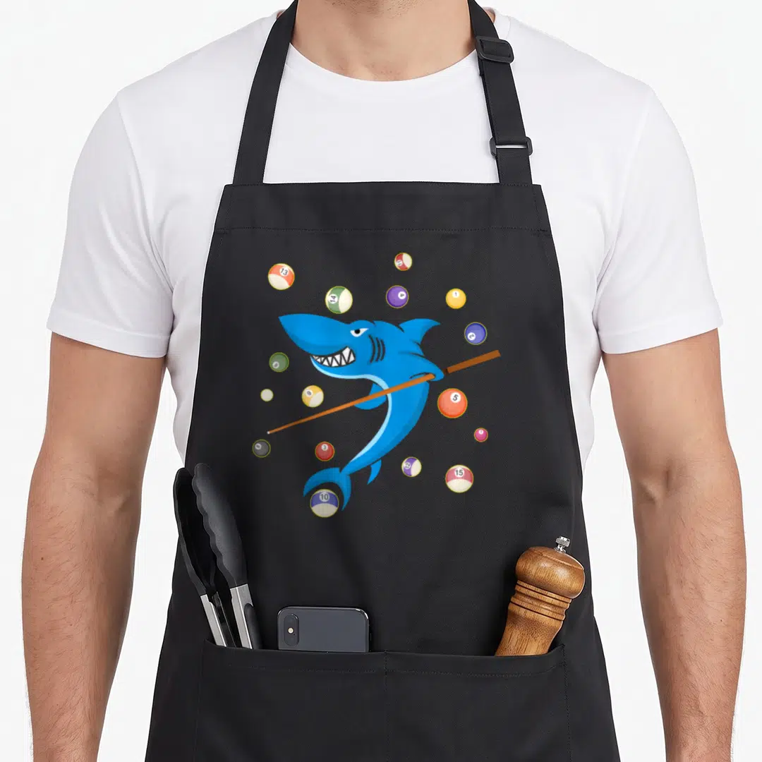 Shark pool table apron - Cartoon blue shark holding brown pool cue surrounded by colorful billiard balls — shown on a black cotton canvas apron against a white background