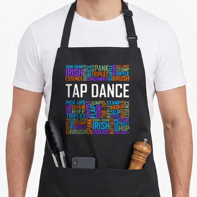 Tap teacher apron - Typography art listing tap dance moves like shim-sham, triplet, and heel-drop in multicolor block — shown on a black cotton canvas apron against a white background