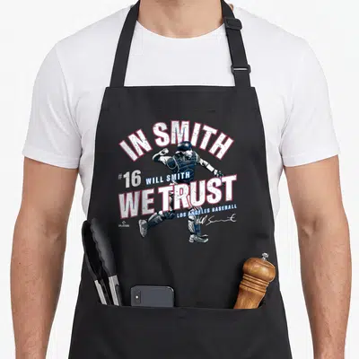 Trust baseball apron - Will Smith catcher illustration with In Smith We Trust text and number 16 — shown on a black cotton canvas apron against a white background