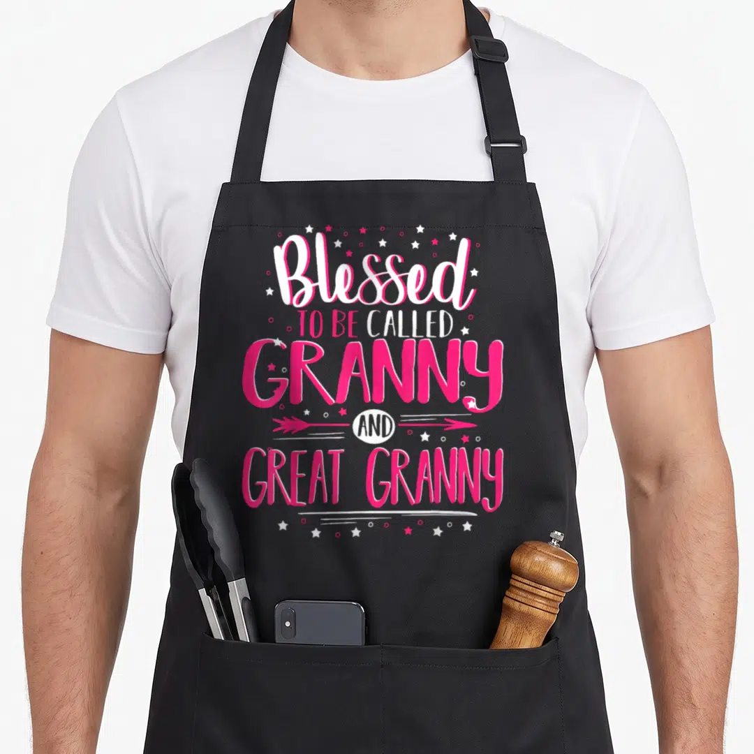 Funny blessed granny apron - Stacked pink and white text Blessed to be called Granny and Great Granny with scattered — shown on a black cotton canvas apron against a white background