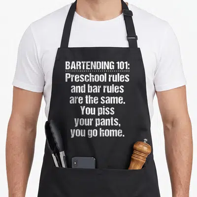 Preschool bartender apron - White distressed text stating preschool and bar rules are the same with sarcasm about — shown on a black cotton canvas apron against a white background