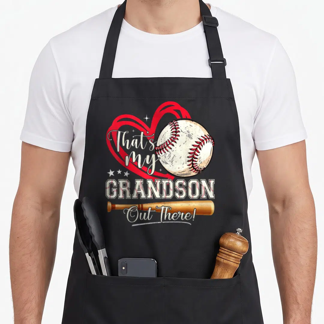 Grandson baseball mother's day aprons - Red heart, baseball, and bat with text That's my GRANDSON Out There! — shown on a black cotton canvas apron against a white background