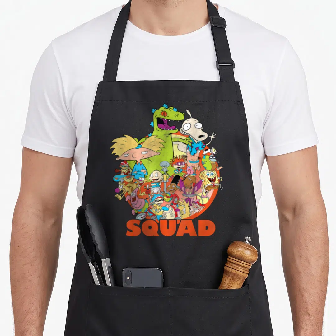 Nicktoon 90s apron - Circular cluster of cartoon characters above bold orange SQUAD text on colored background — shown on a black cotton canvas apron against a white background