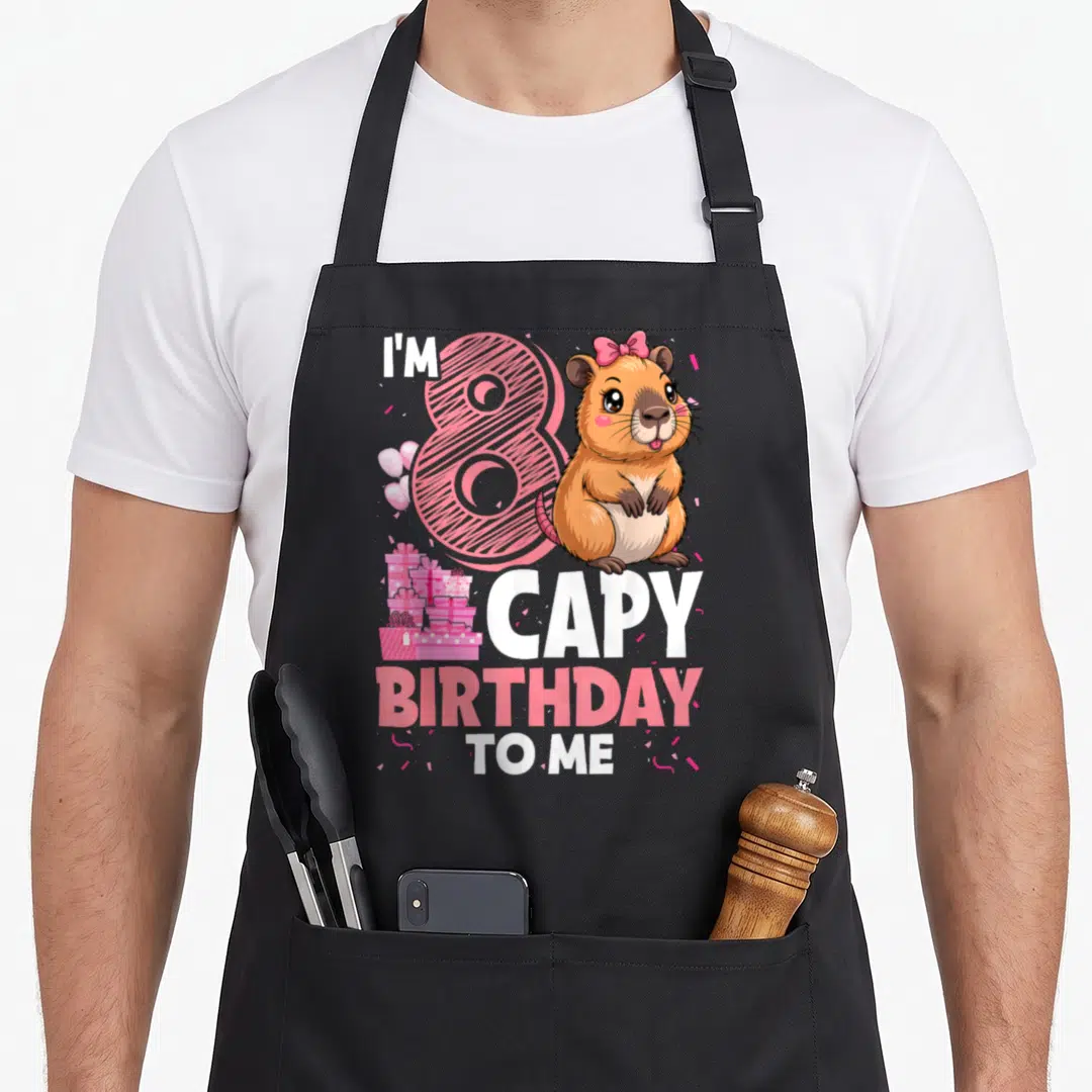 Capy 8th capybara birthday apron - Pink number 8, brown capybara, I'M CAPY BIRTHDAY TO ME text — shown on a black cotton canvas apron against a white background
