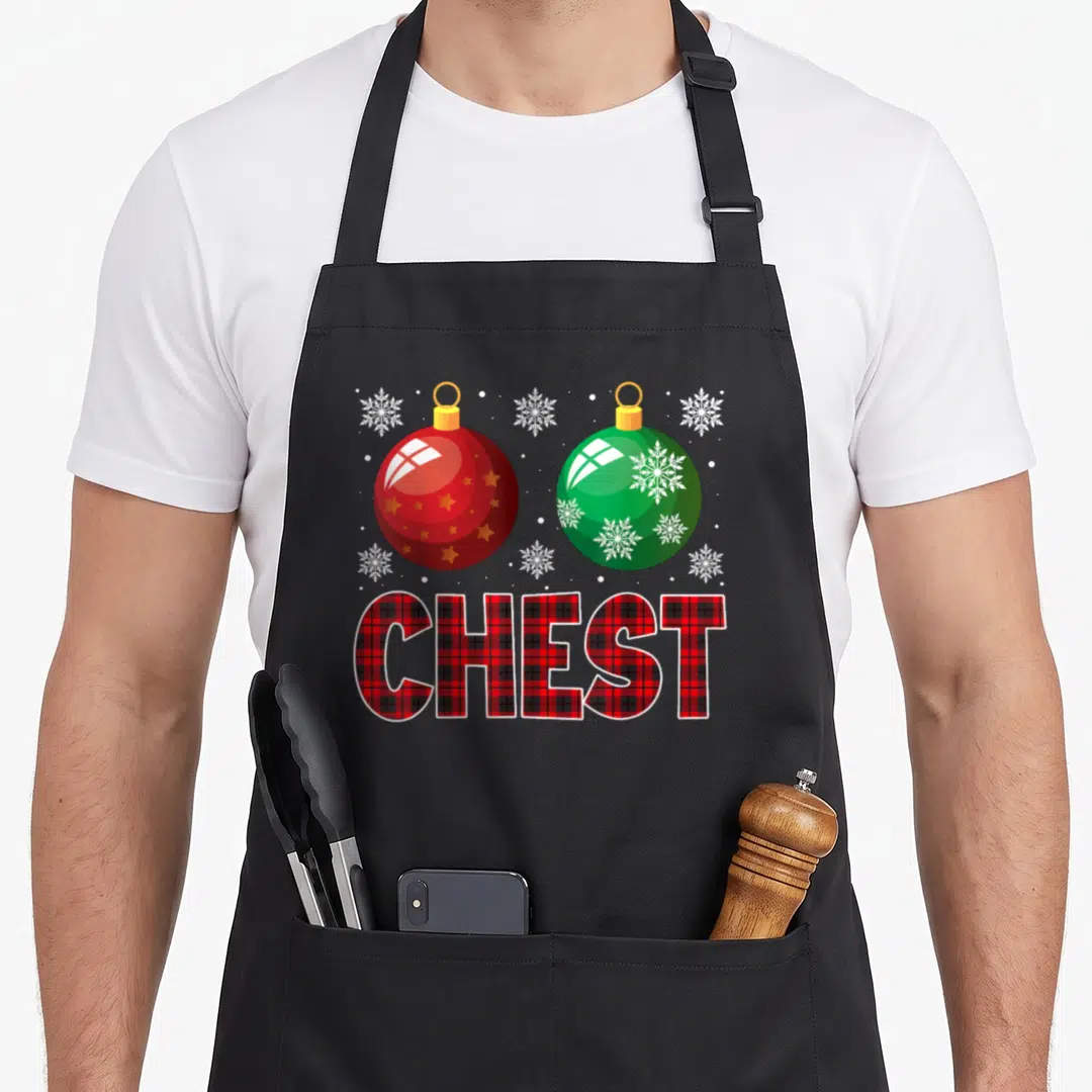 Retro nut couples christmas aprons - Red and green ornaments with CHEST plaid text and white snowflakes — shown on a black cotton canvas apron against a white background