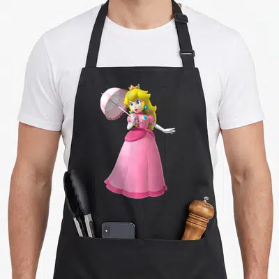 Poster princess apron - Full body Princess Peach in pink dress holding open umbrella in 3D cartoon style — shown on a black cotton canvas apron against a white background