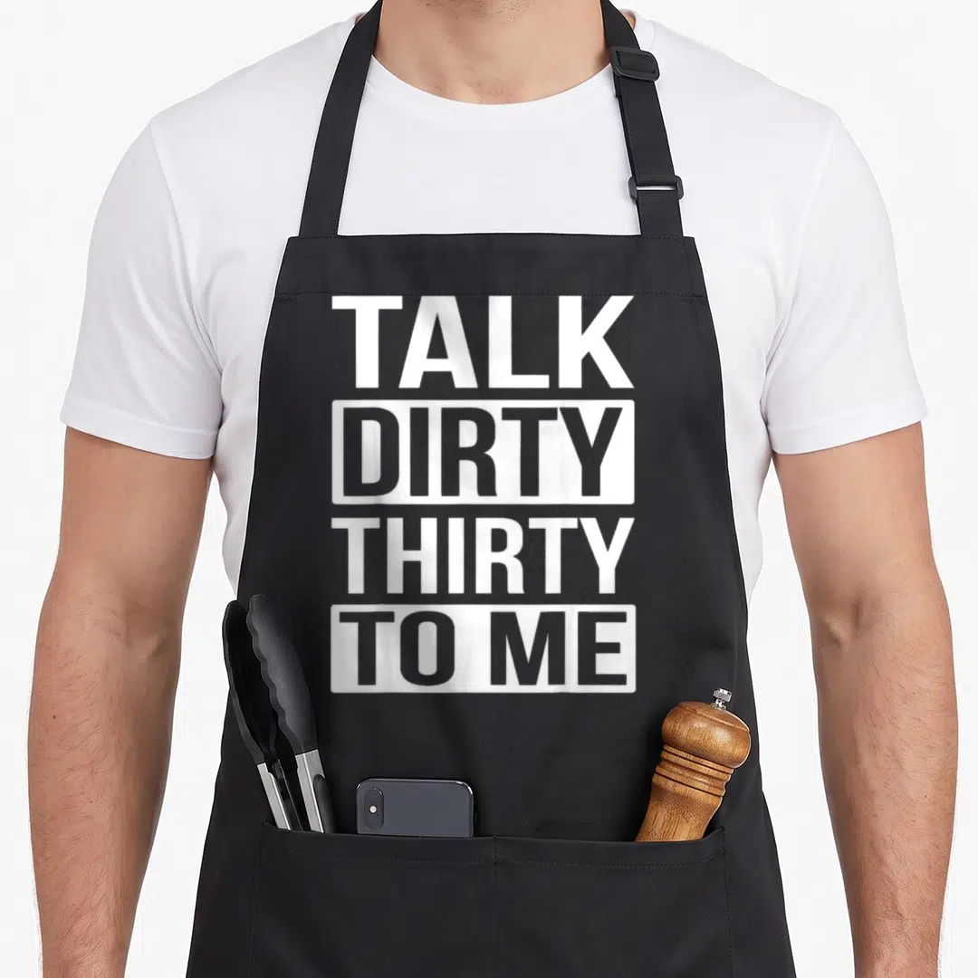 Talk funny dirty aprons - White stacked text TALK DIRTY THIRTY TO ME on black background — shown on a black cotton canvas apron against a white background