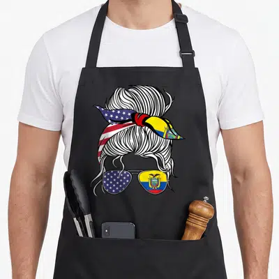 Patriot ecuador american flag apron - Cartoon messy bun with US and Ecuador flag bandana above matching sunglasses — shown on a black cotton canvas apron against a white background