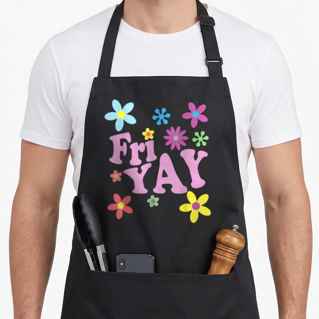Yay friday teacher apron - Pink Fri YAY text with pink yellow blue purple green red flowers — shown on a black cotton canvas apron against a white background
