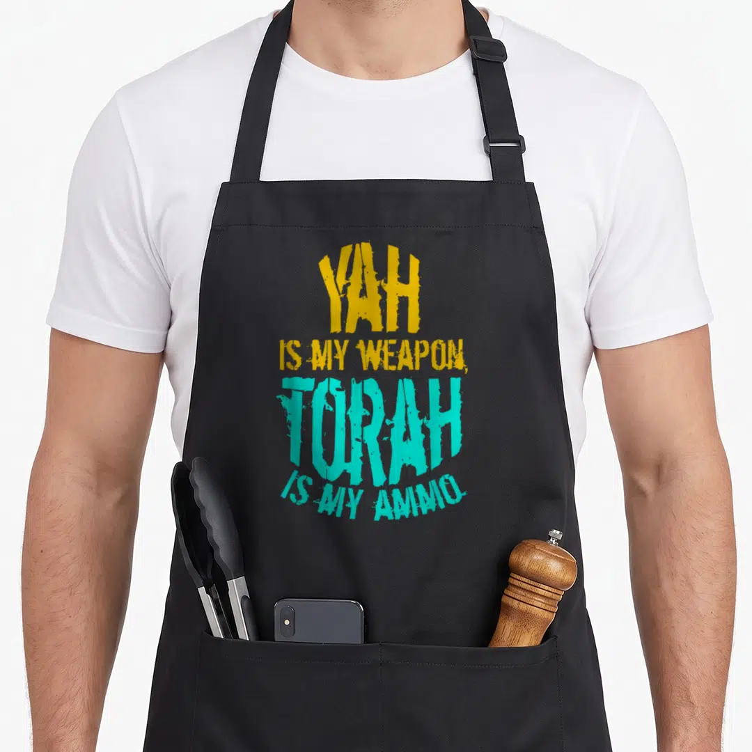 Yah hebrew aprons - Stacked yellow and turquoise distressed text reading YAH IS MY WEAPON TORAH IS MY AMMO — shown on a black cotton canvas apron against a white background
