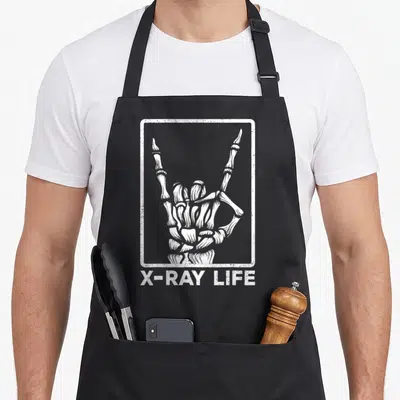 Xray halloween themed aprons - White skeleton hand in distressed frame with X-RAY LIFE text below — shown on a black cotton canvas apron against a white background