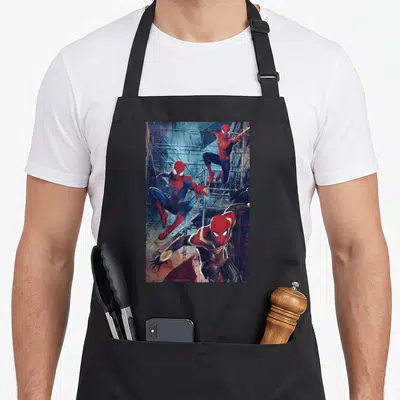 Way terrible apron - Three Spider-Men leaping and crouching on grey scaffolding in red and blue suits — shown on a black cotton canvas apron against a white background