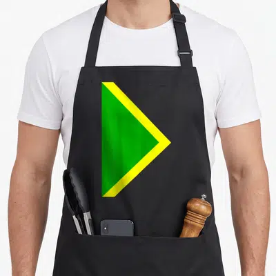 Bobsled halloween apron - Green and yellow triangular flag design on black bib apron — shown on a black cotton canvas apron against a white background