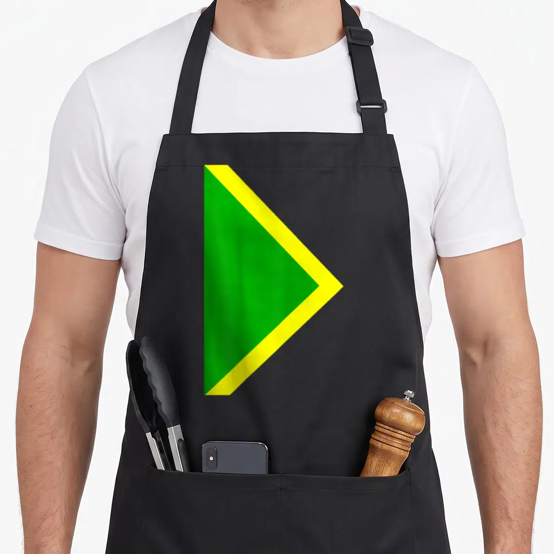 Bobsled halloween apron - Green and yellow triangular flag design on black bib apron — shown on a black cotton canvas apron against a white background