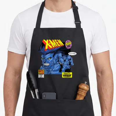 Beast hobby apron - X-Men comic cover print showing Beast face and full body pose with stars and garters quote — shown on a black cotton canvas apron against a white background
