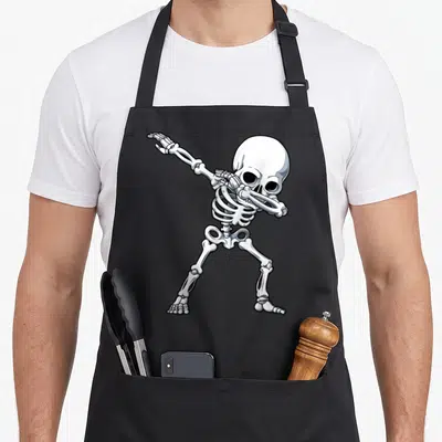 Halloween dabbing skeleton apron - White and grey cartoon skeleton figure in a dynamic dabbing dance pose with black — shown on a black cotton canvas apron against a white background