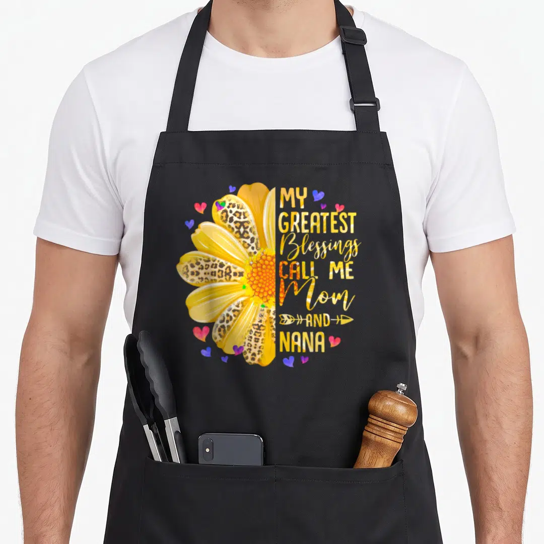 Blessing mother's day aprons - Yellow daisy with leopard print petals and stacked text reading My Greatest Blessings — shown on a black cotton canvas apron against a white background