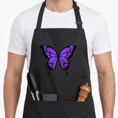Vibrant butterfly apron - Purple and black cartoon butterfly graphic centered on an apron front — shown on a black cotton canvas apron against a white background