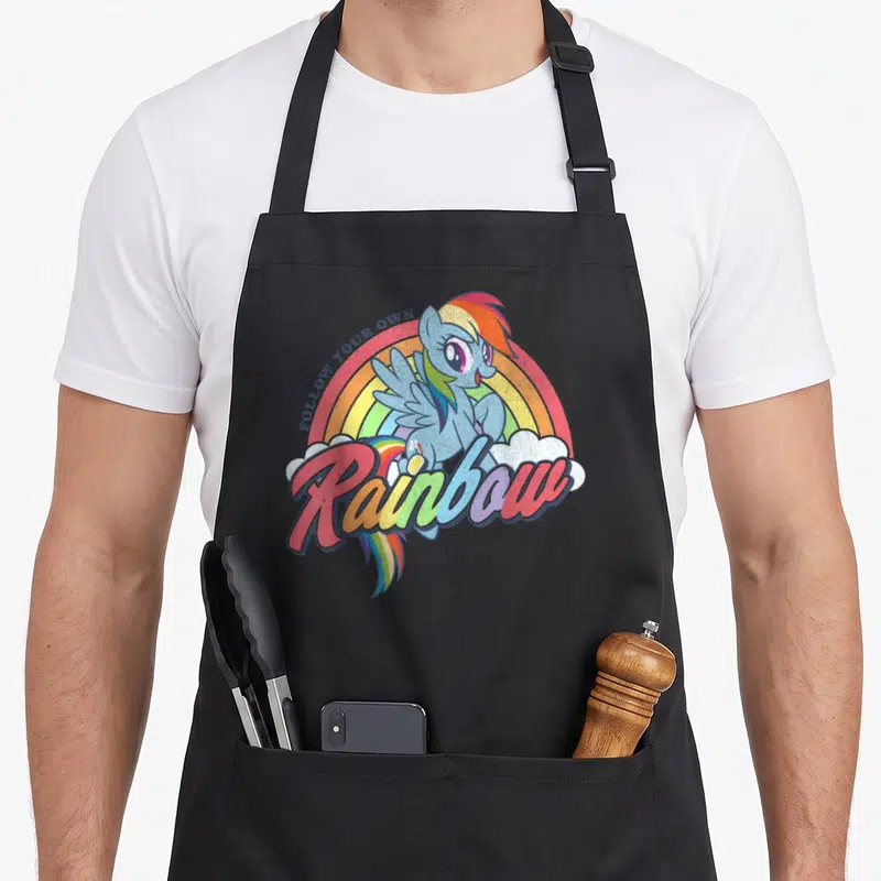 Dash rainbow apron - Blue pony with rainbow text and clouds on canvas apron — shown on a black cotton canvas apron against a white background