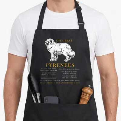 Funny pyrenee dog apron - White line art Great Pyrenees dog with yellow title text and white descriptive facts about — shown on a black cotton canvas apron against a white background