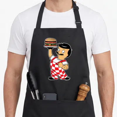 Funny bob bobsled apron - Cartoon chef in red checkered pants holding a burger on a plate — shown on a black cotton canvas apron against a white background