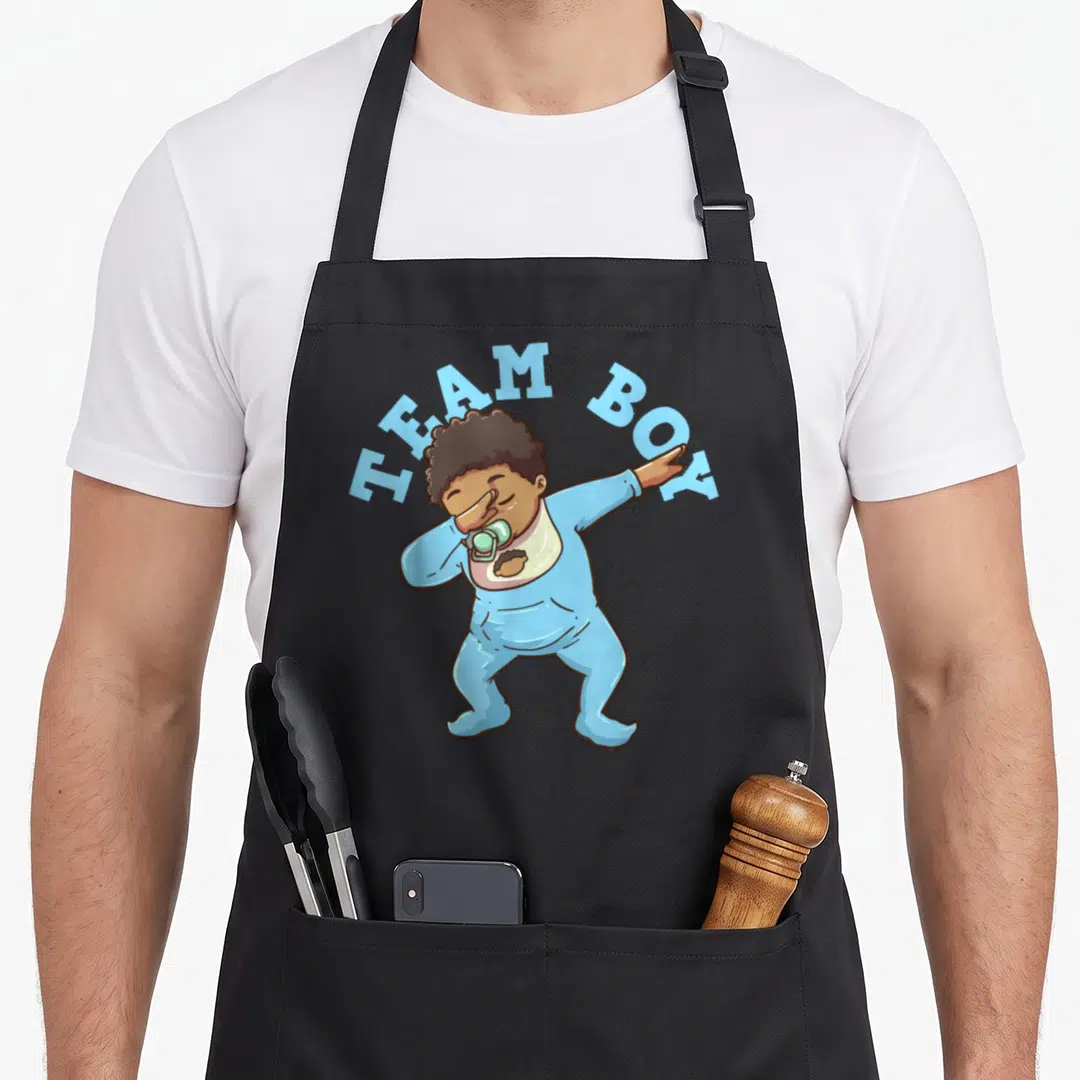 Gender pregnancy by company apron - Cartoon baby dabbing in blue onesie under arched TEAM BOY text — shown on a black cotton canvas apron against a white background