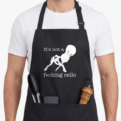 Cello upright double apron - White cello silhouette and bow with sarcastic text It's not a f*cking cello — shown on a black cotton canvas apron against a white background