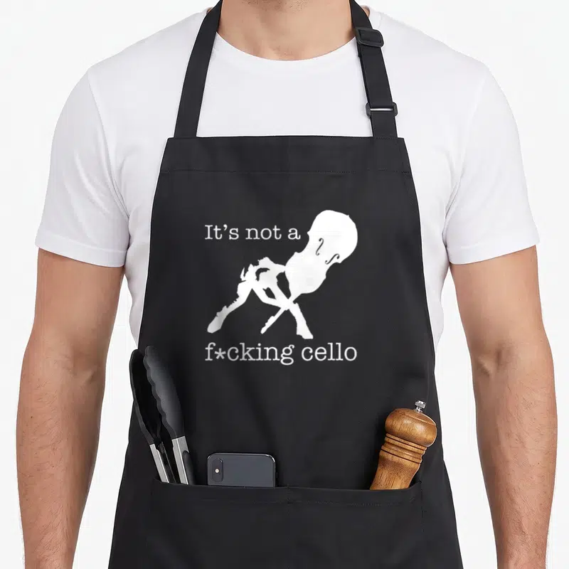 Cello upright double apron - White cello silhouette and bow with sarcastic text It's not a f*cking cello — shown on a black cotton canvas apron against a white background