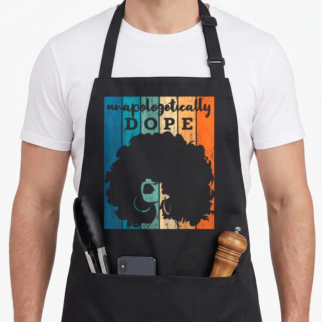 Unapologetically african american aprons - grey afro silhouette under stacked unapologetically DOPE text — shown on a black cotton canvas apron against a white background