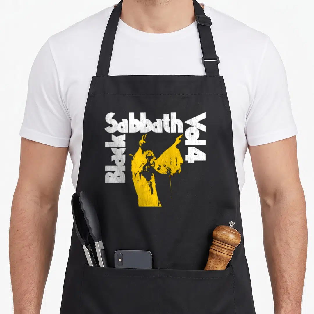 Sabbath vol black officially apron - Distressed white text framing a yellow person silhouette — shown on a black cotton canvas apron against a white background