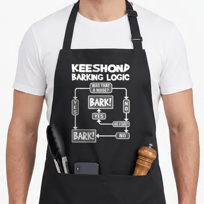 Logic dog apron - White flowchart diagram titled Keeshond Barking Logic with YES NO text boxes — shown on a black cotton canvas apron against a white background