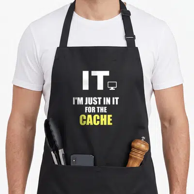 Tech geek apron - Stacked text IT I'M JUST IN IT FOR THE CACHE with monitor icon in white and yellow — shown on a black cotton canvas apron against a white background