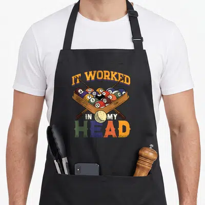 Snooker pool apron - Retro graphic of billiard balls in a rack with cues and IT WORKED IN MY HEAD text — shown on a black cotton canvas apron against a white background