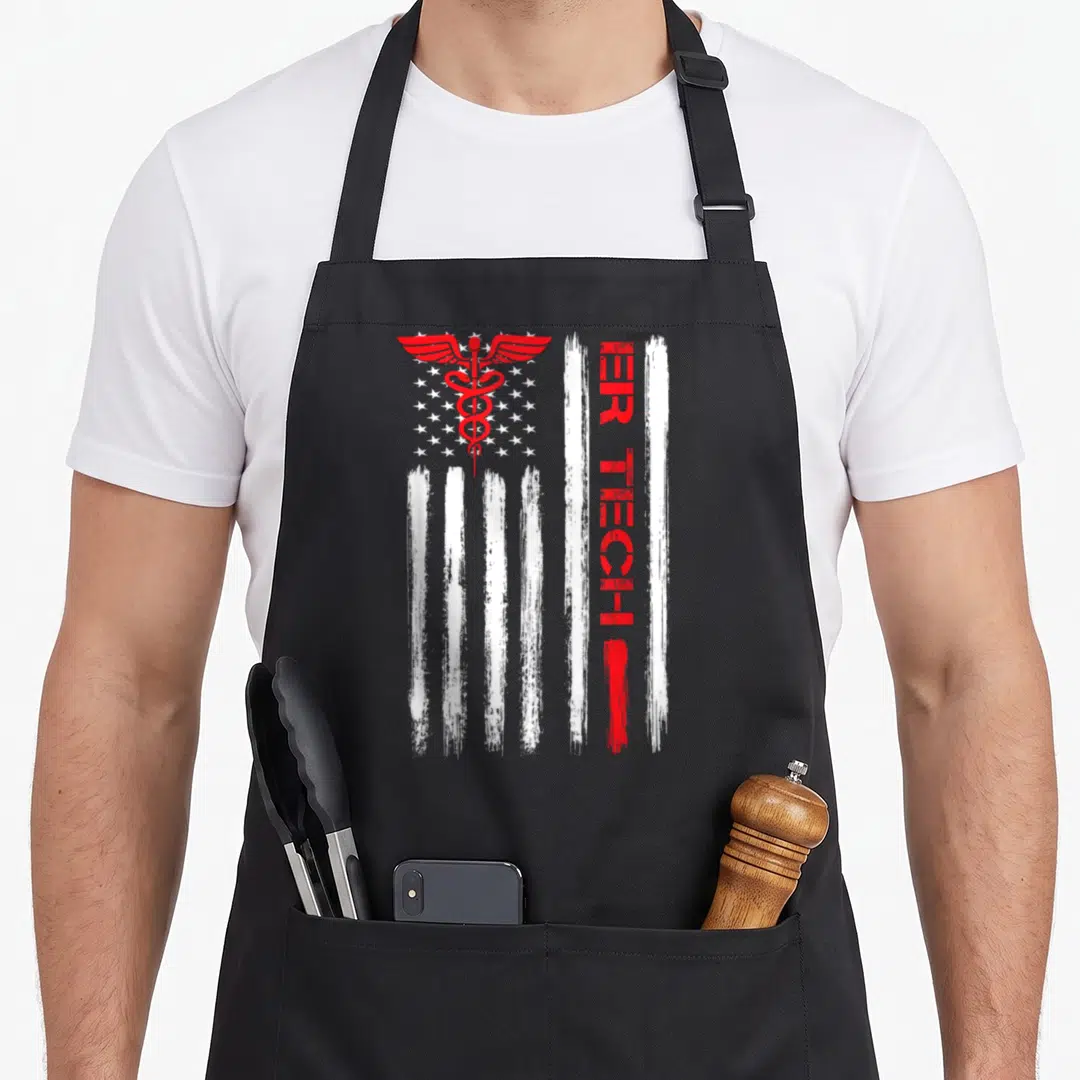 Tech us aprons - Red caduceus over white stars and distressed stripes with vertical ER TECH text — shown on a black cotton canvas apron against a white background