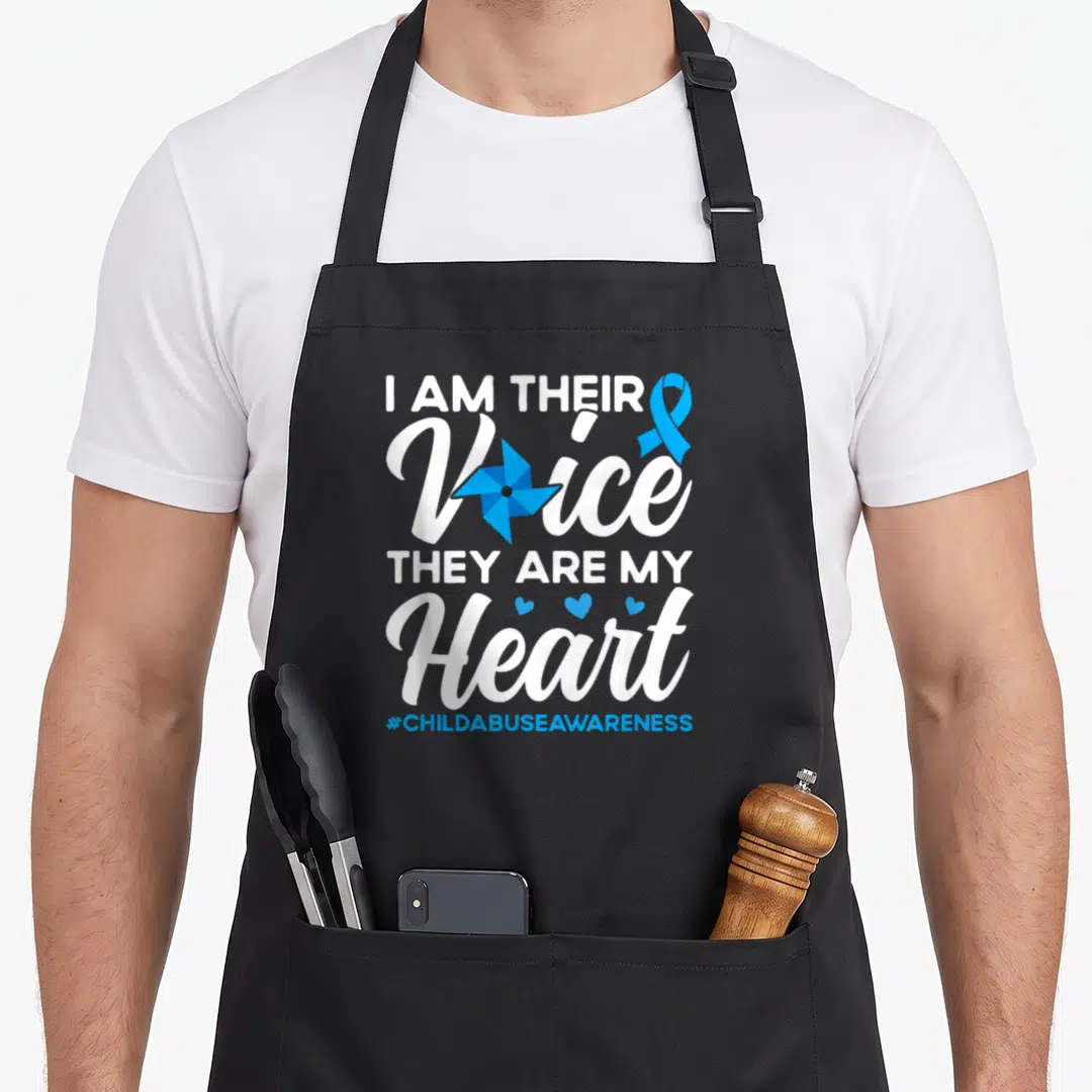 Voice child abuse prevention apron - White and blue stacked text reading I AM THEIR Voice THEY ARE MY Heart with ribbon — shown on a black cotton canvas apron against a white background