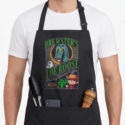 Brewster crossover apron - Blue-grey pigeon in orange wreath with BREWSTER'S THE ROOST text and coffee cup character — shown on a black cotton canvas apron against a white background