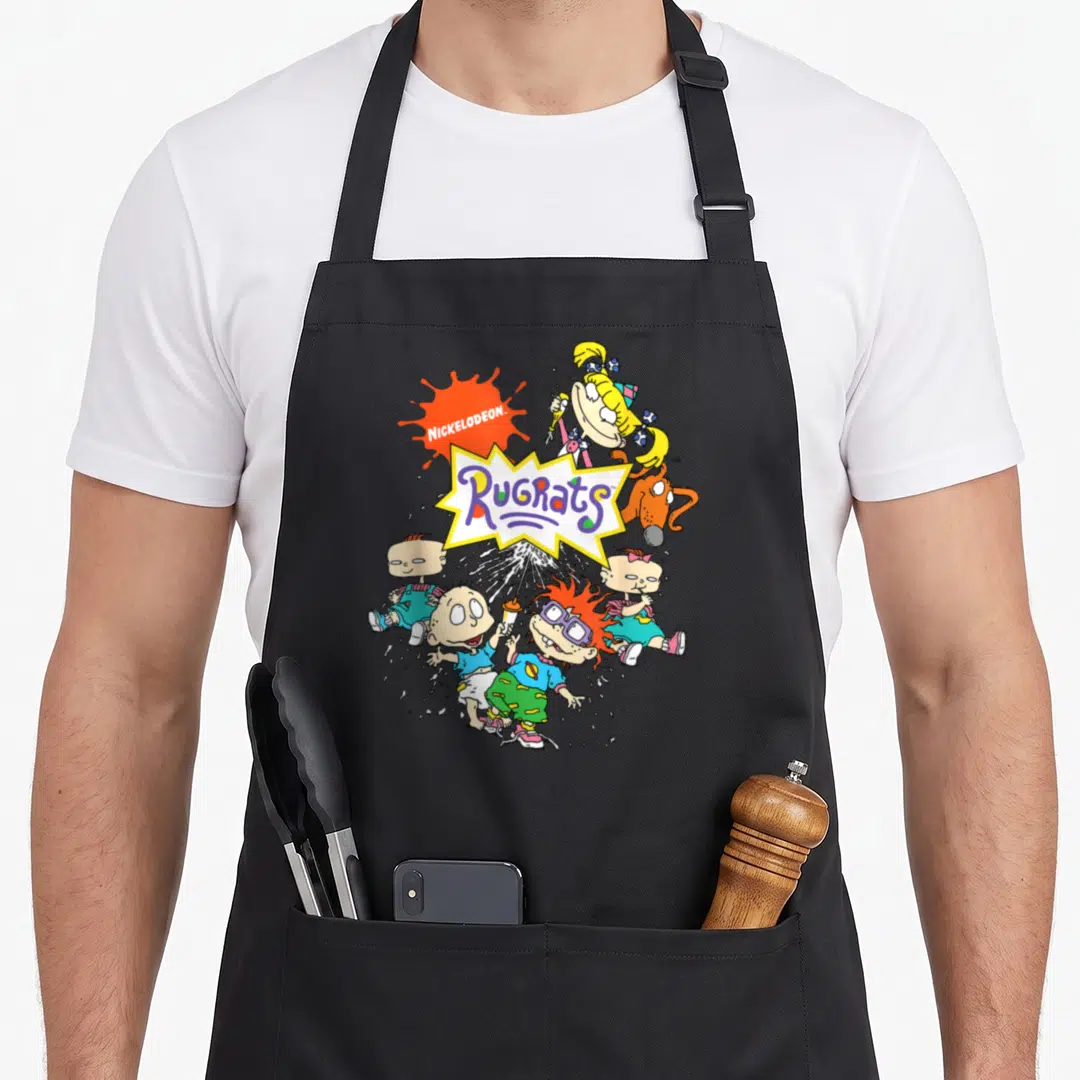 Cute portrait character aprons - Rugrats logo surrounded by cartoon babies in orange, yellow, blue, and purple — shown on a black cotton canvas apron against a white background