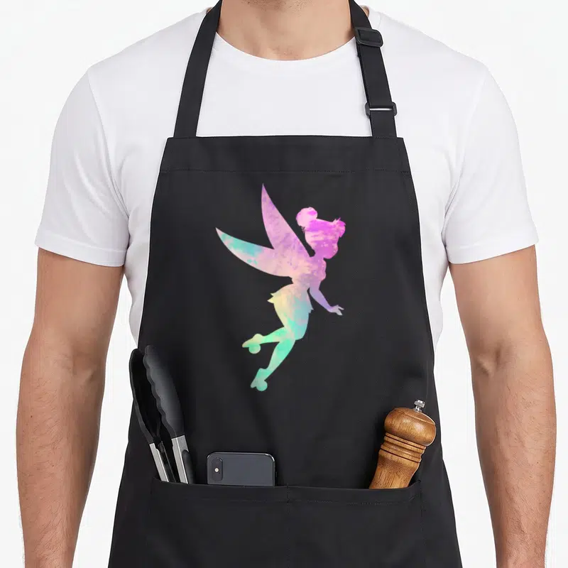 Peter tie apron - Fairy silhouette filled with pink purple blue green yellow watercolor gradient — shown on a black cotton canvas apron against a white background