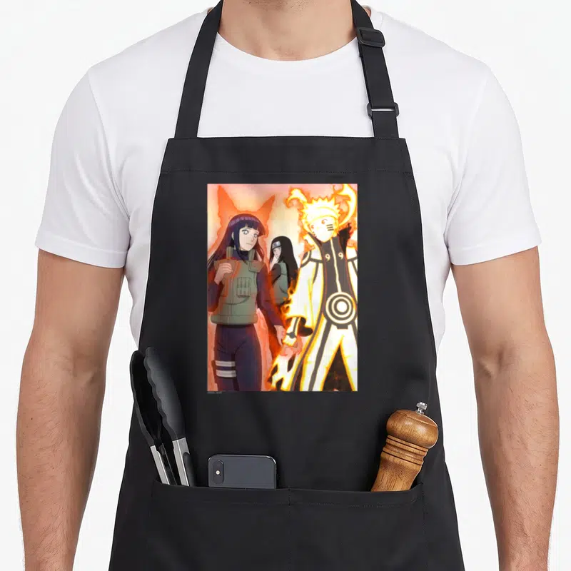 Shippuden couple apron - Naruto Uzumaki and Hinata holding hands surrounded by orange flames with Hanabi in background — shown on a black cotton canvas apron against a white background