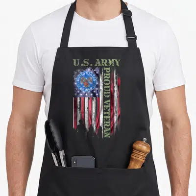Army proud american flag apron - Distressed US flag with U.S. Army seal and vertical Proud Veteran text in olive green — shown on a black cotton canvas apron against a white background