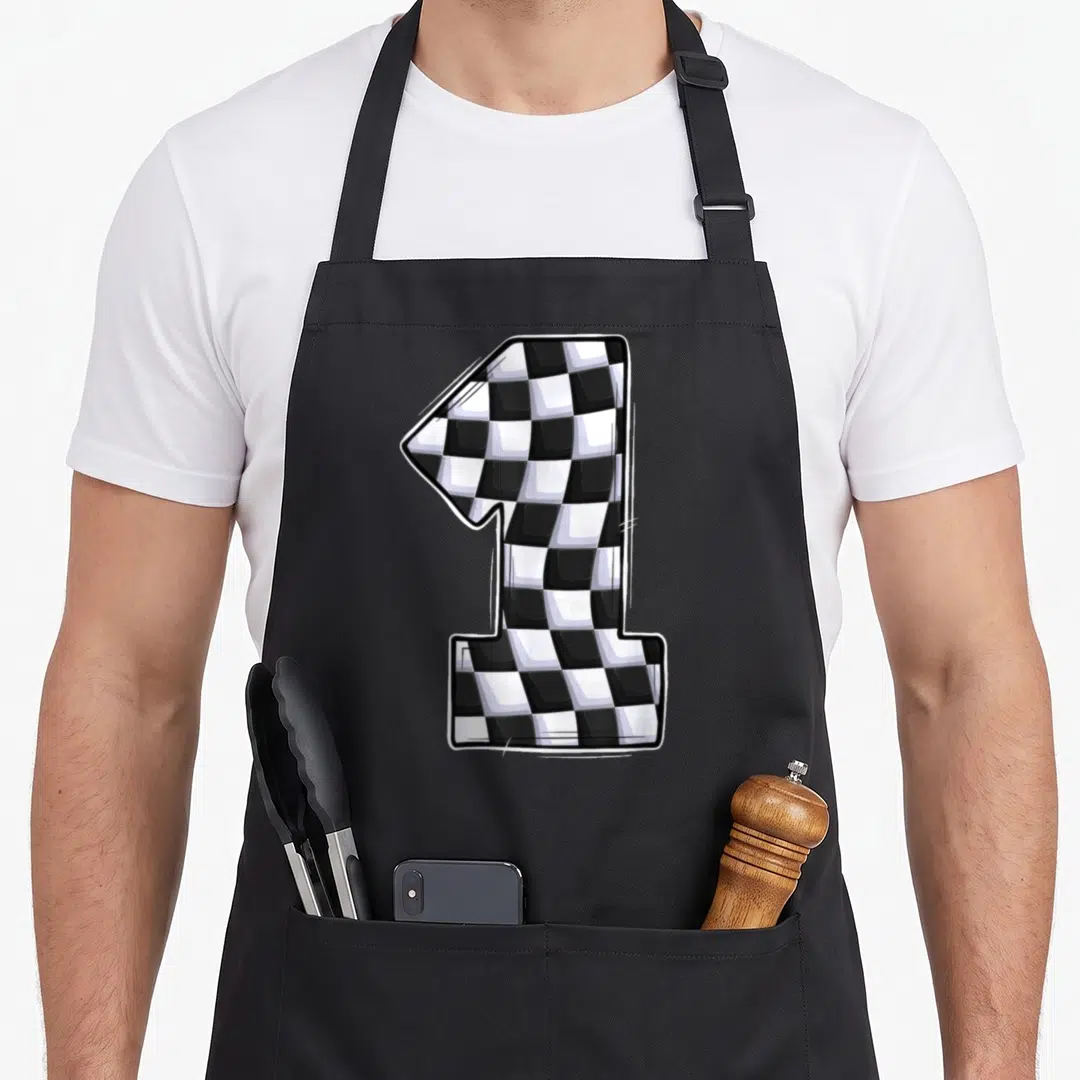 1st car apron - Cartoon number 1 filled with black and white checkered pattern — shown on a black cotton canvas apron against a white background
